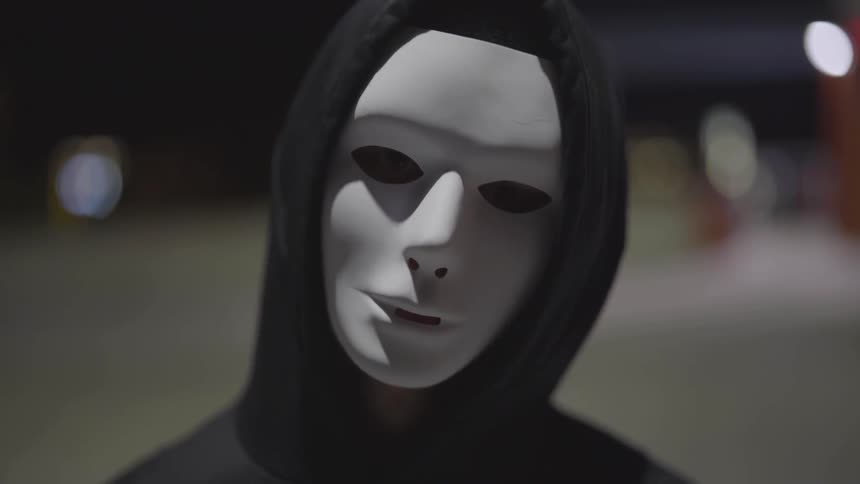 Man Wearing Mask With A Gun At Night