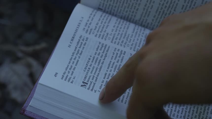 Man With Bible Walking On Train Tracks