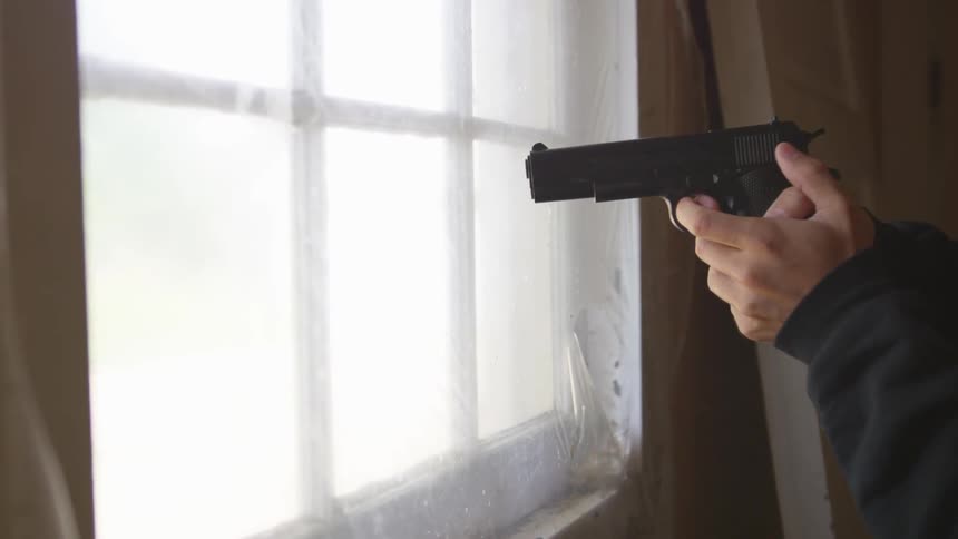 Man With Gun In Abandoned House