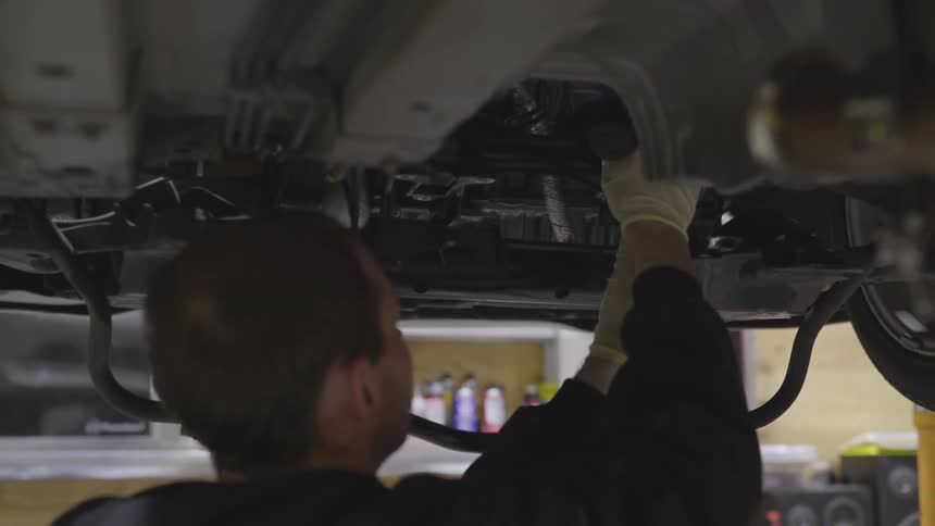 Mechanic Working On Car