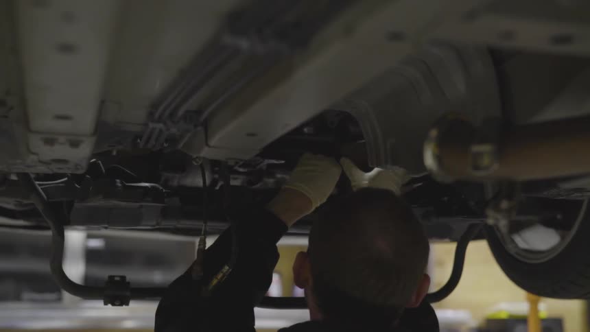 Mechanic Working On Car