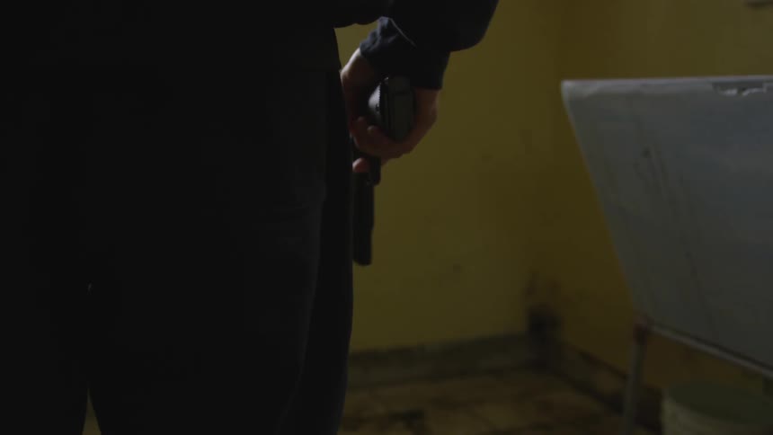Man With Gun In Abandoned House