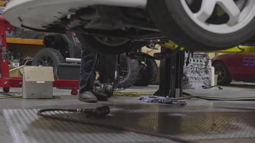 Mechanic Working On Car