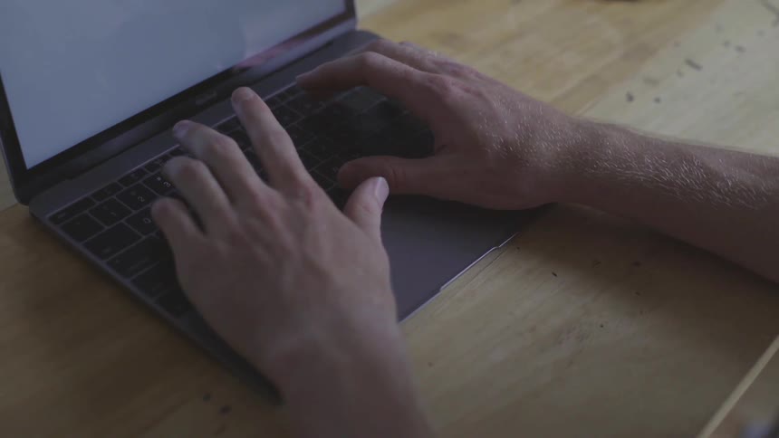 Man Using Laptop At Desk