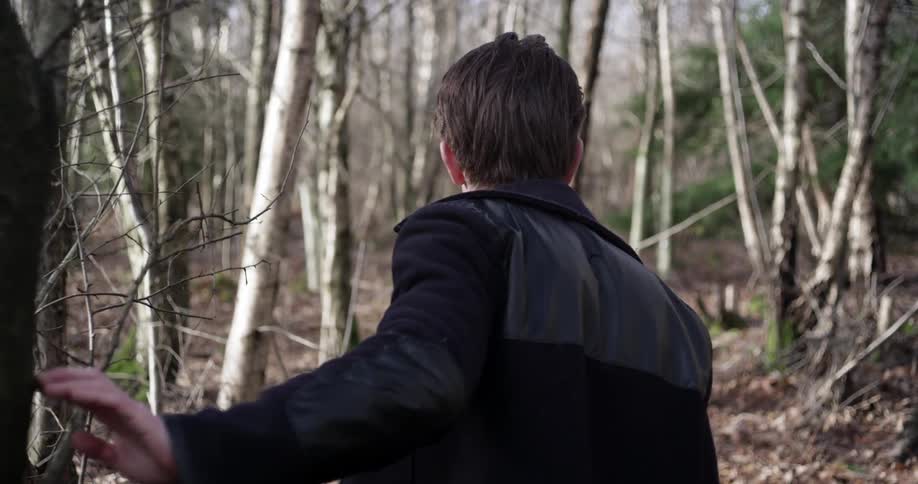 A man walking through a wooded area