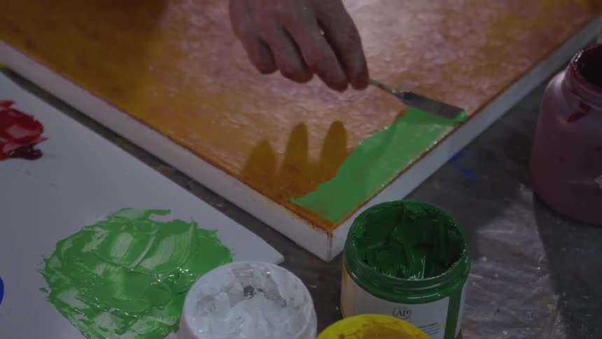 Older Man Painting In Studio