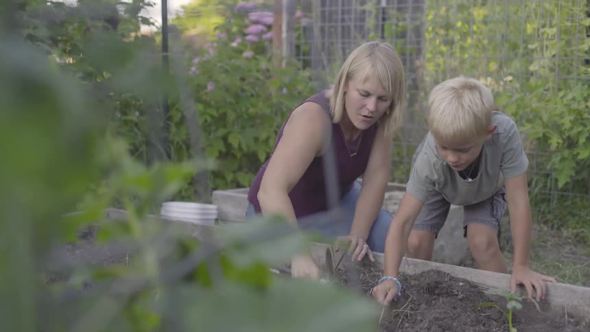 Mother And Son Gardening Together