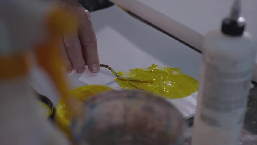 Older Man Painting In Studio