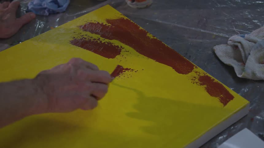 Older Man Painting In Studio