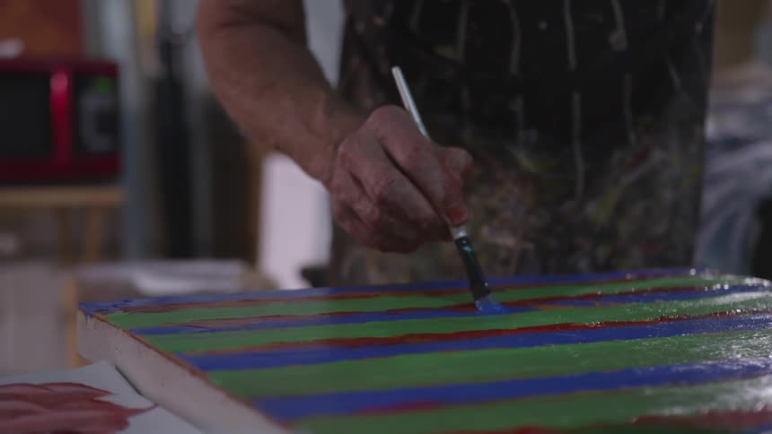 Older Man Painting In Studio