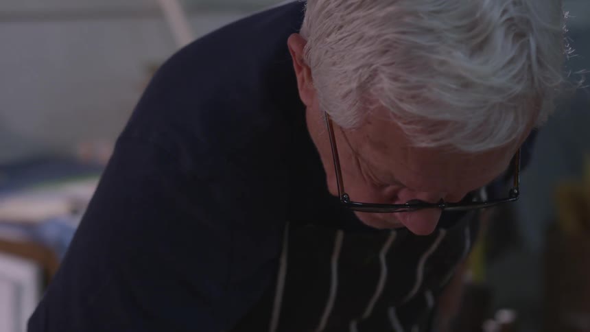 Older Man Painting In Studio