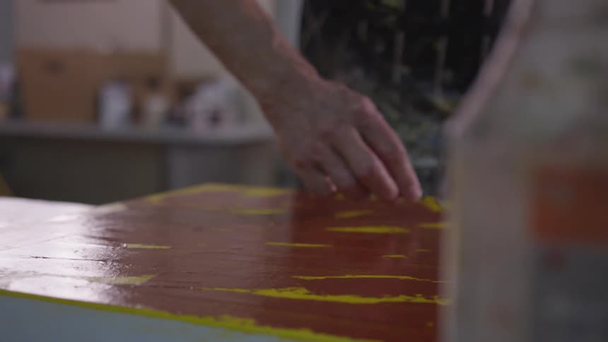 Older Man Painting In Studio