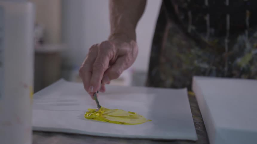 Older Man Painting In Studio