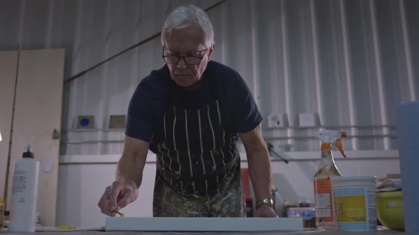 Older Man Painting In Studio
