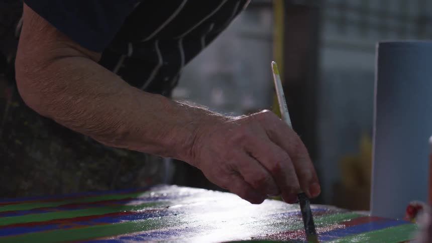 Older Man Painting In Studio