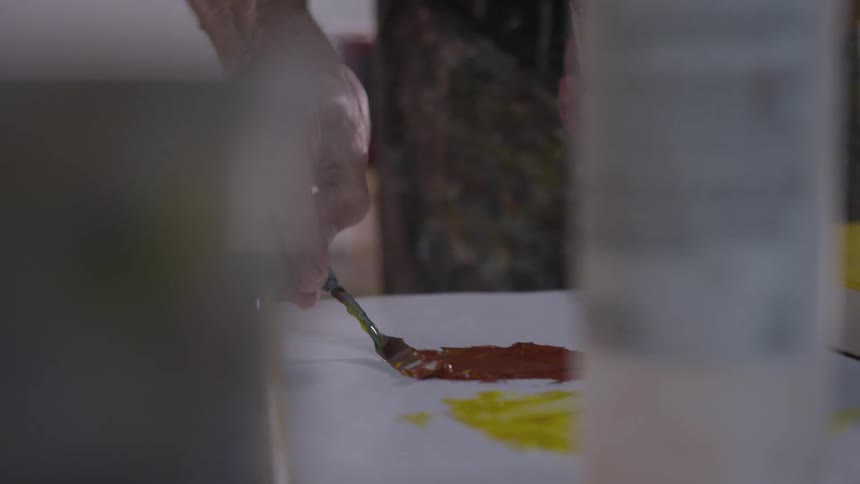 Older Man Painting In Studio
