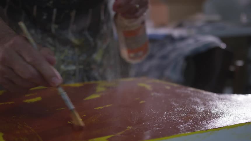 Older Man Painting In Studio