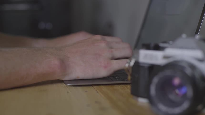 Man Using Laptop At Desk