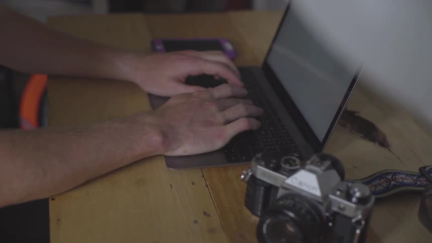 Man Using Laptop At Desk