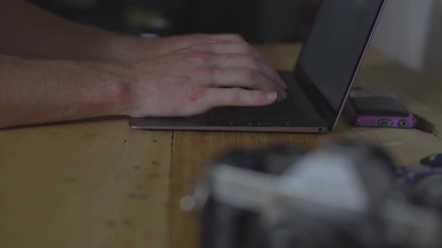 Man Using Laptop At Desk