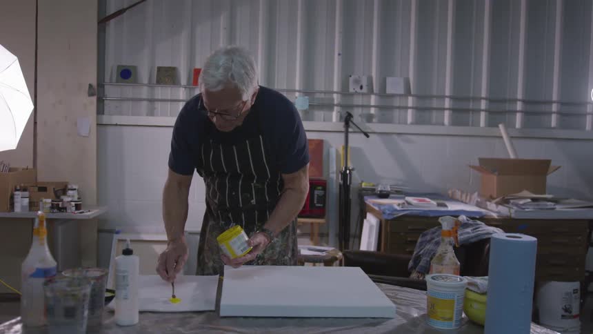 Older Man Painting In Studio