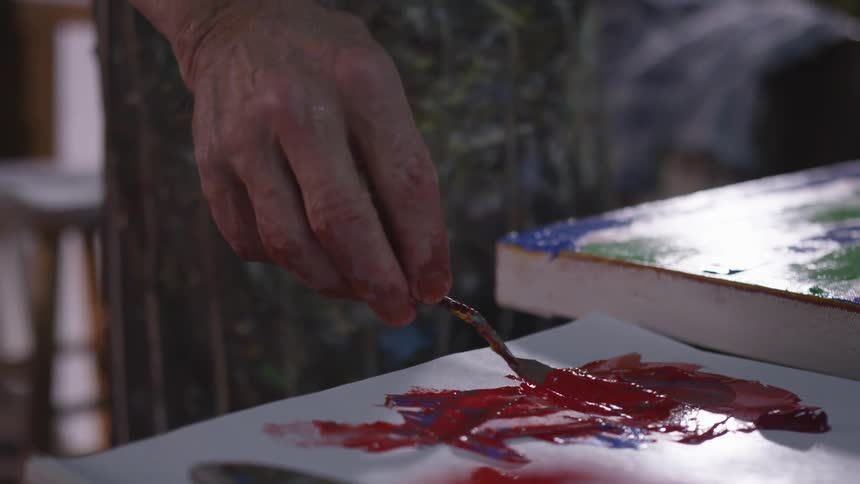 Older Man Painting In Studio