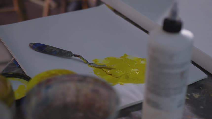 Older Man Painting In Studio