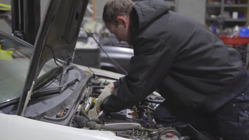 Mechanic Working On Car