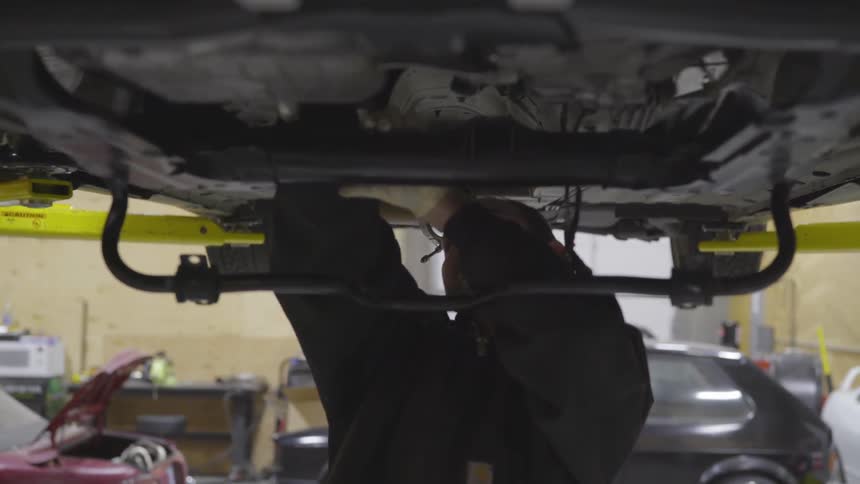 Mechanic Working On Car