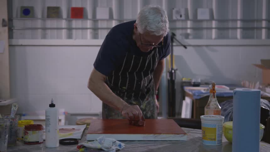 Older Man Painting In Studio