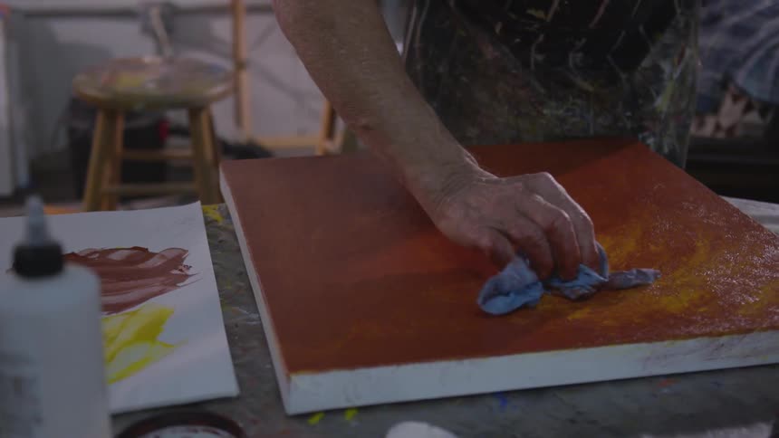 Older Man Painting In Studio