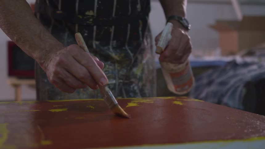 Older Man Painting In Studio