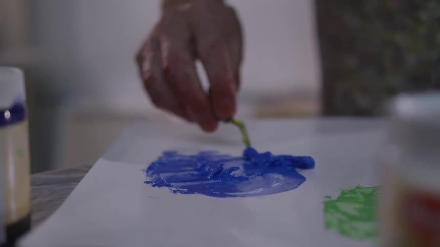 Older Man Painting In Studio