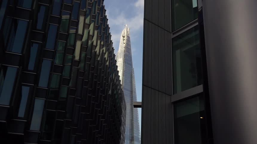 View between two buildings with a taller building up ahead