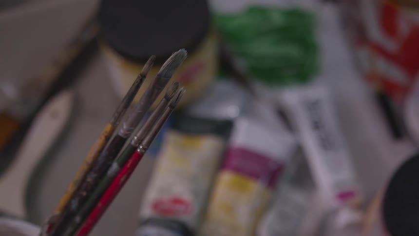 Older Man Painting In Studio