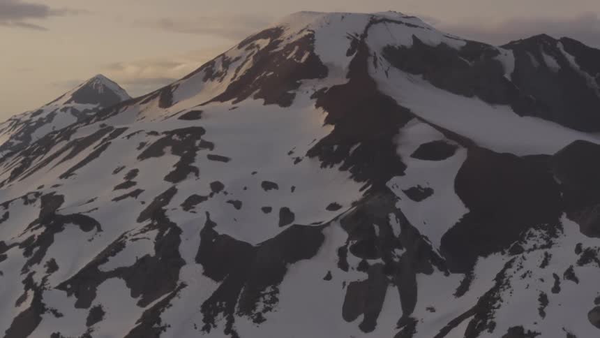Pilot Flying Plane Through Snowy Mountains