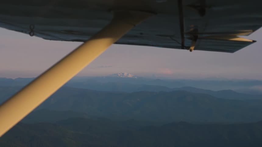 Pilot Flying Plane Through Snowy Mountains