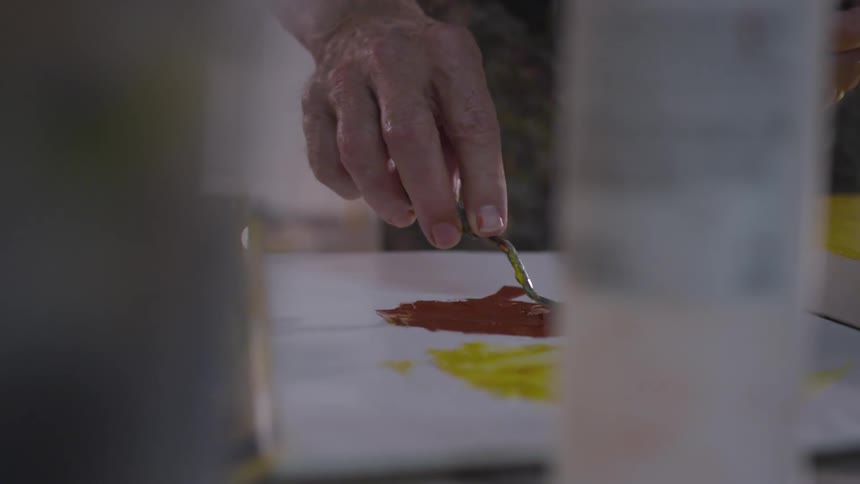 Older Man Painting In Studio