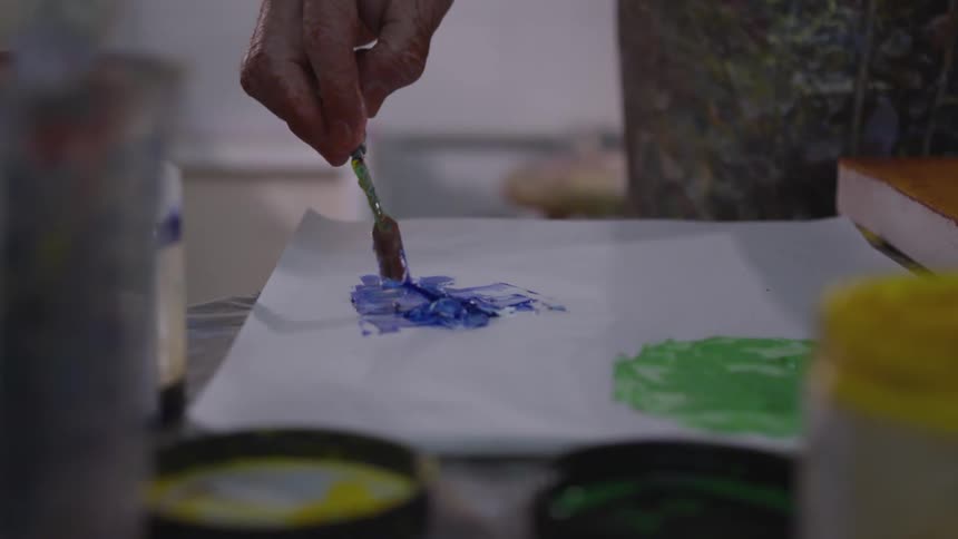 Older Man Painting In Studio