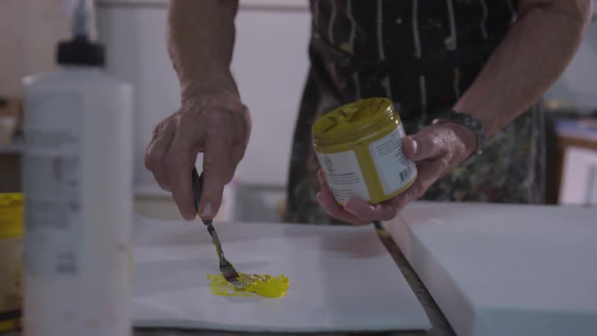Older Man Painting In Studio