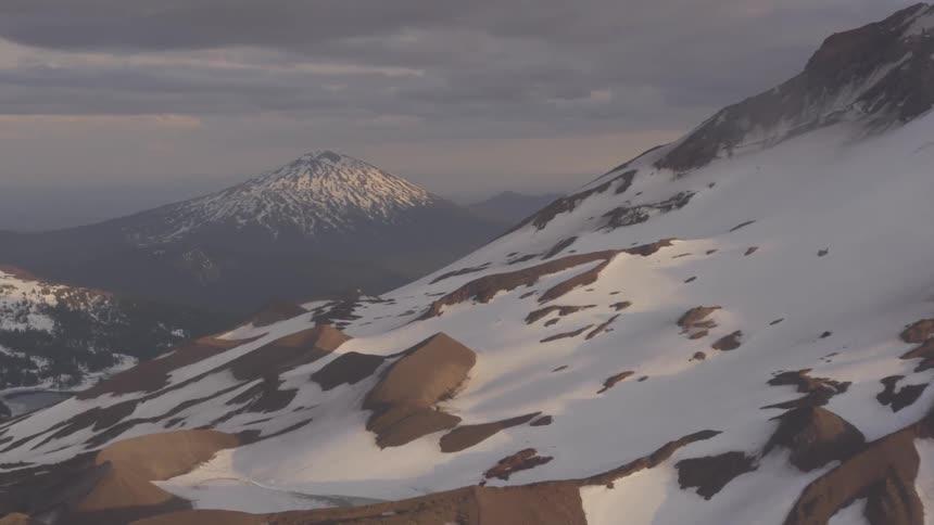 Pilot Flying Plane Through Snowy Mountains