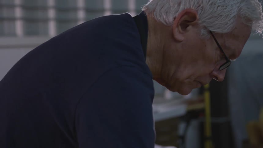 Older Man Painting In Studio