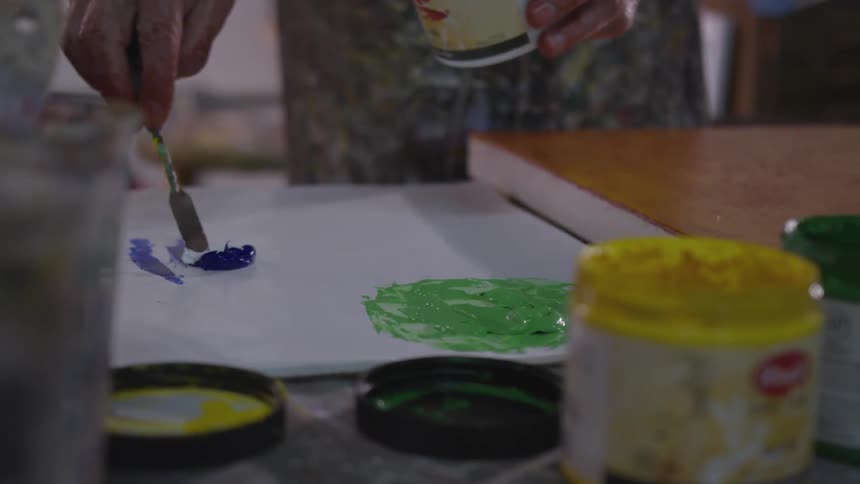 Older Man Painting In Studio