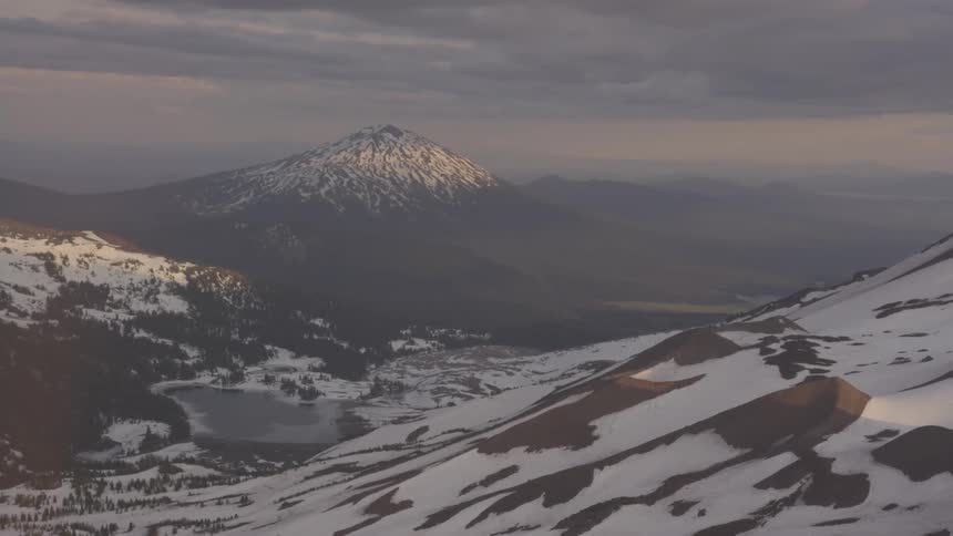 Pilot Flying Plane Through Snowy Mountains