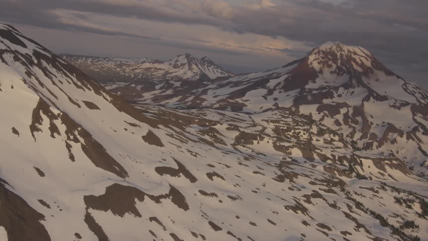 Pilot Flying Plane Through Snowy Mountains
