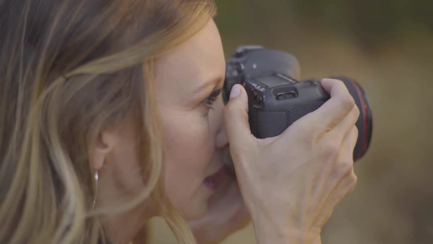 Photographer Taking Pictures Of Woman