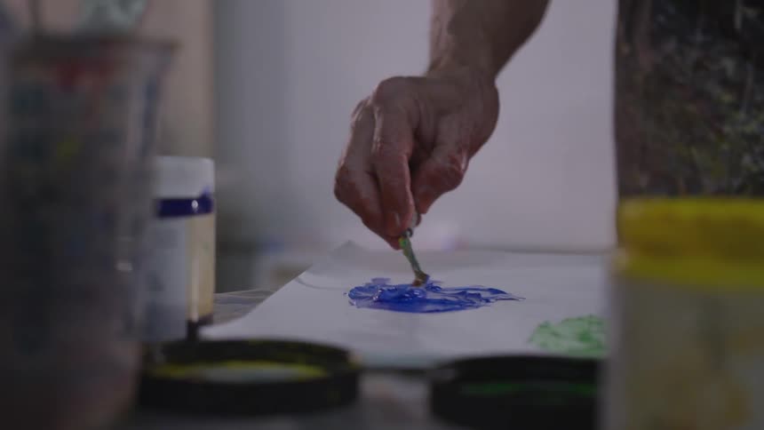 Older Man Painting In Studio