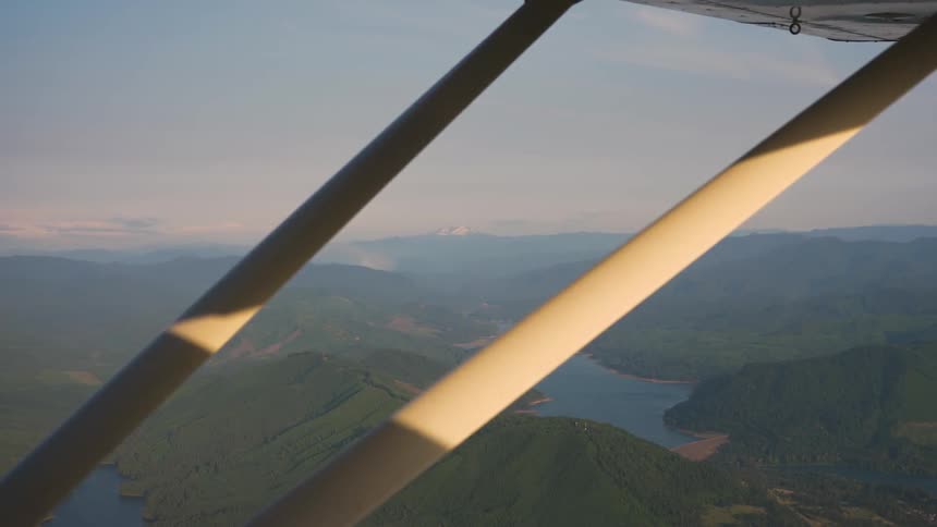 Pilot Flying Plane Through Snowy Mountains