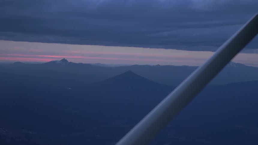 Pilot Flying Plane Through Snowy Mountains