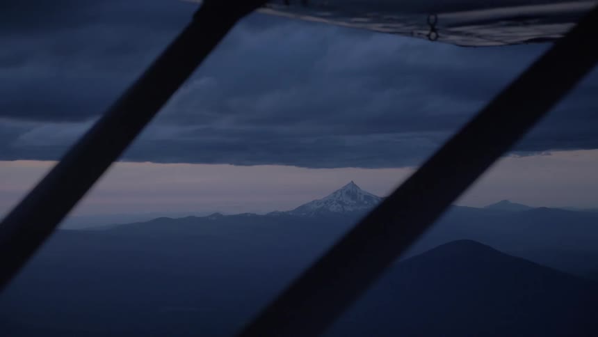 Pilot Flying Plane Through Snowy Mountains